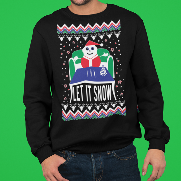 Person wearing a black sweater with a Christmas design on a green background